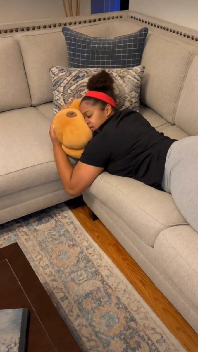 Hugging the Boonzy pillow on the couch